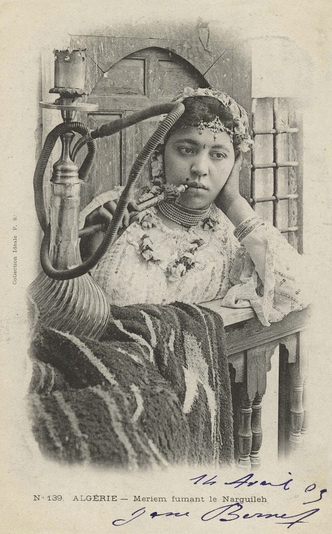 Postcard of an Algerian girl smoking a narghile, early 20th century.